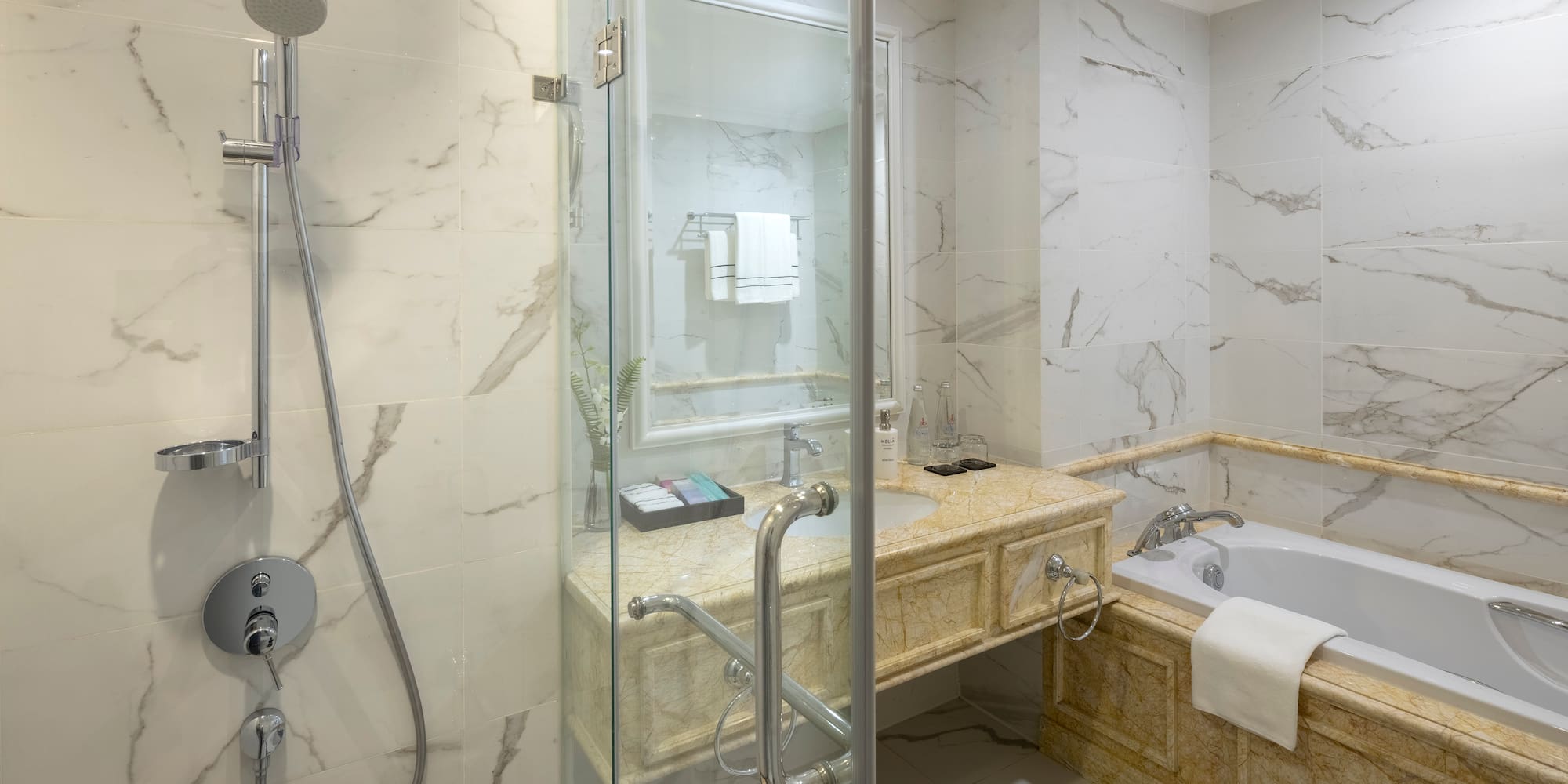 a bathroom with a glass shower door and tub
