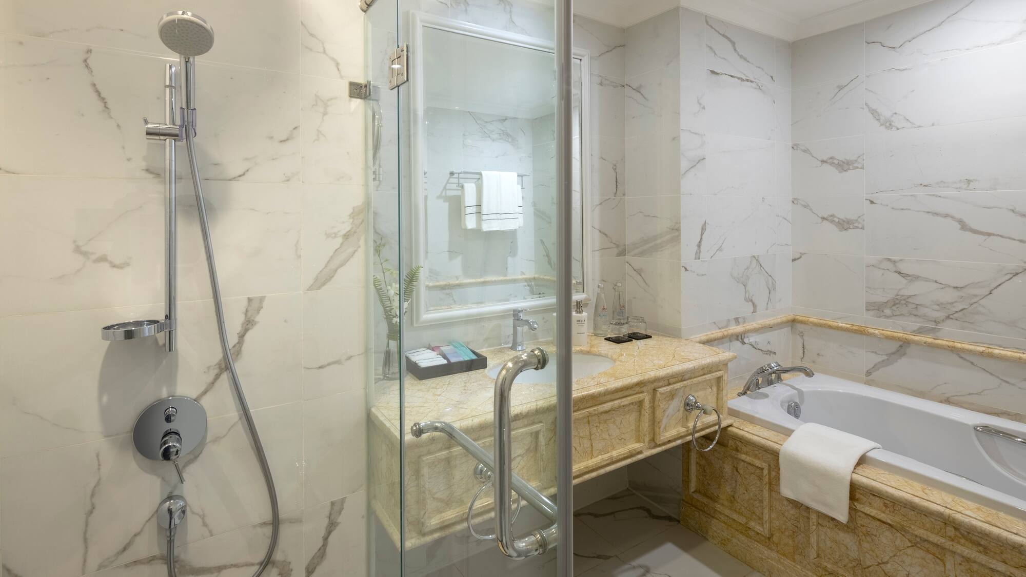 a bathroom with a glass shower door and tub