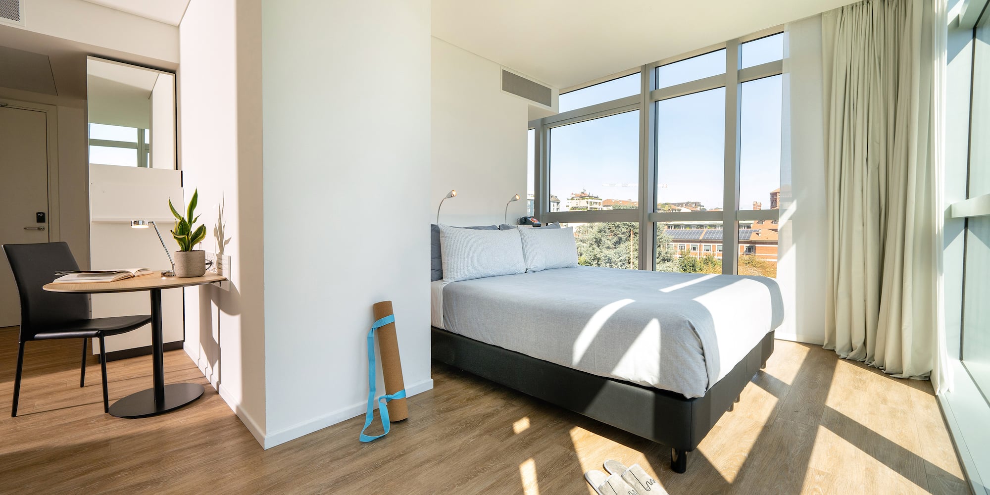 a bedroom with a bed and a window