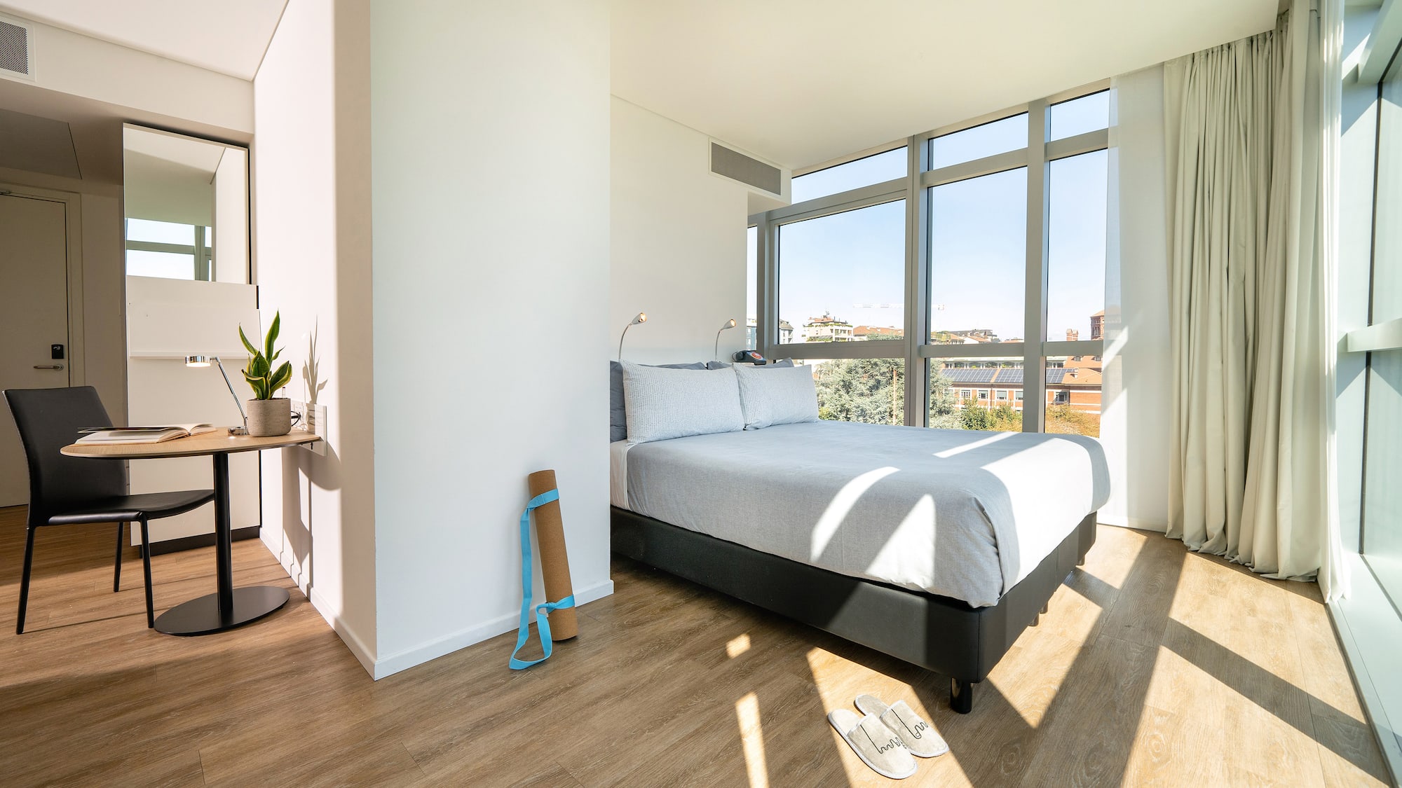 a bedroom with a bed and a window