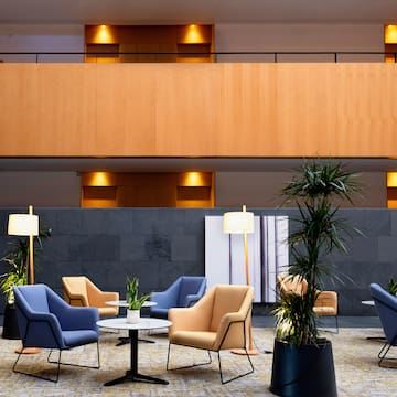 a room with chairs and tables and plants