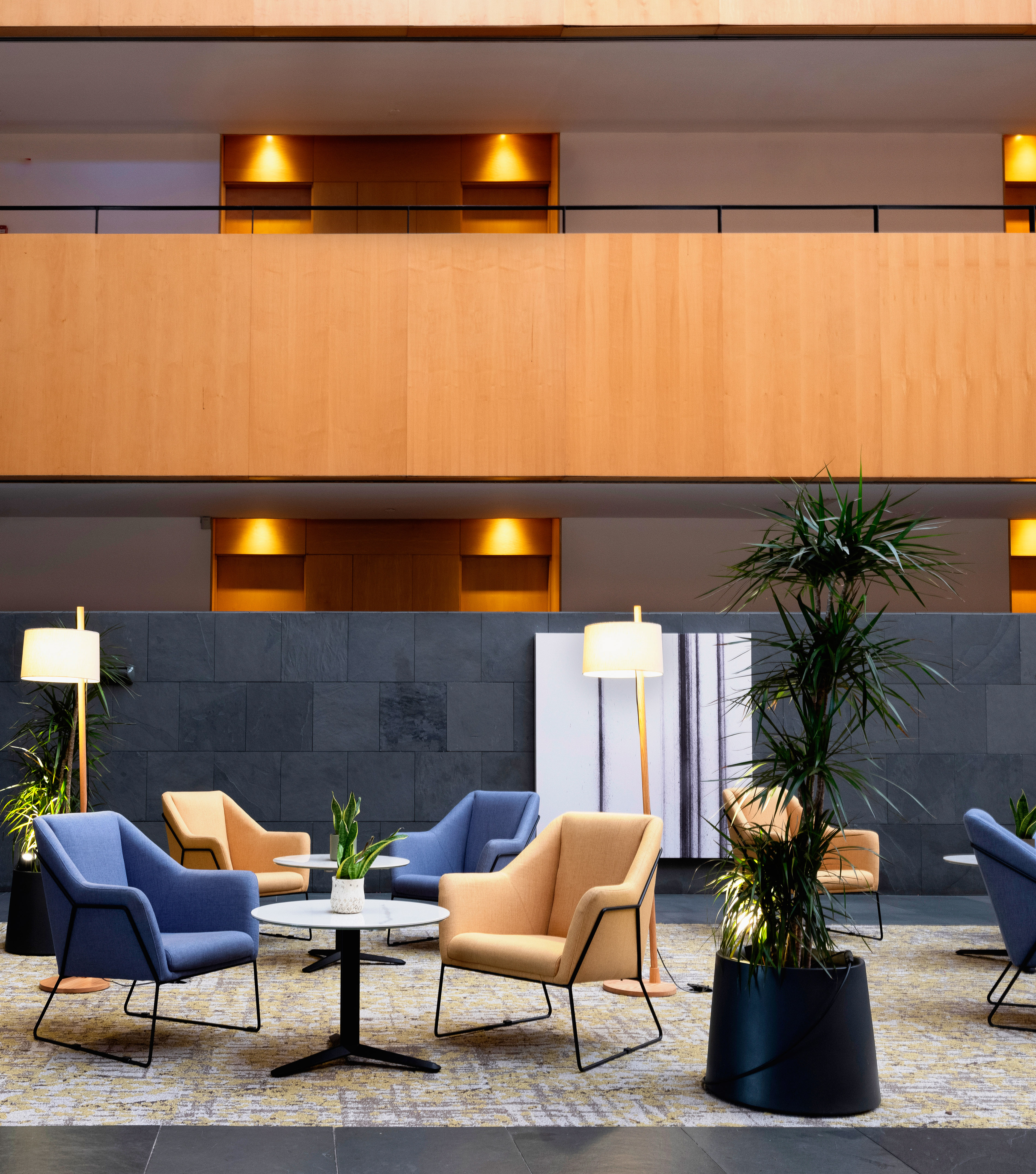 a room with chairs and tables and plants