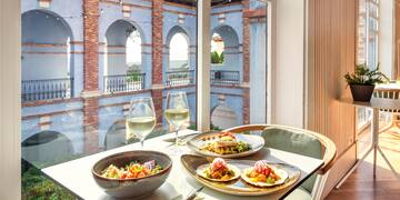 a table with plates of food and wine glasses on it