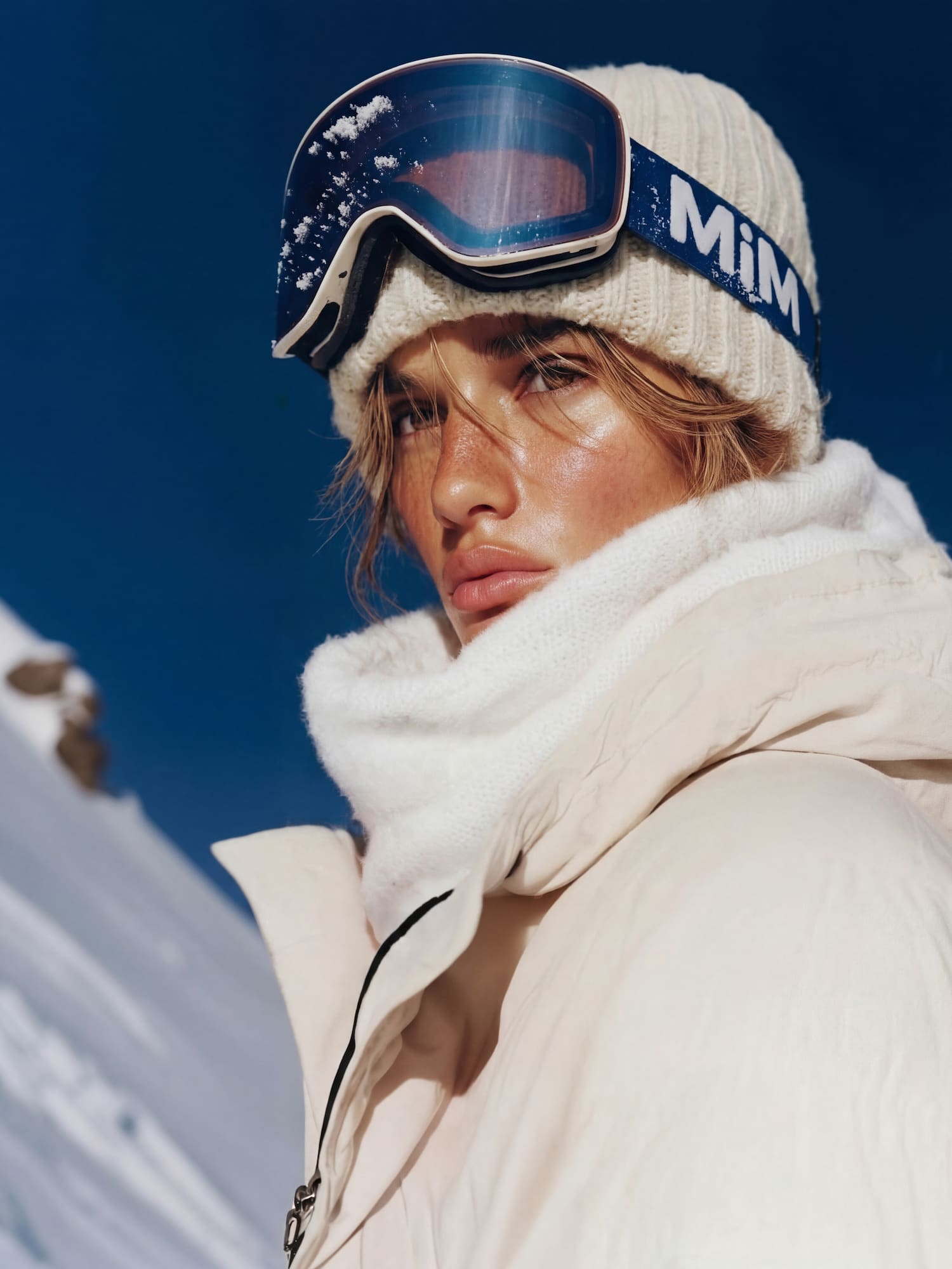a woman wearing a hat and goggles