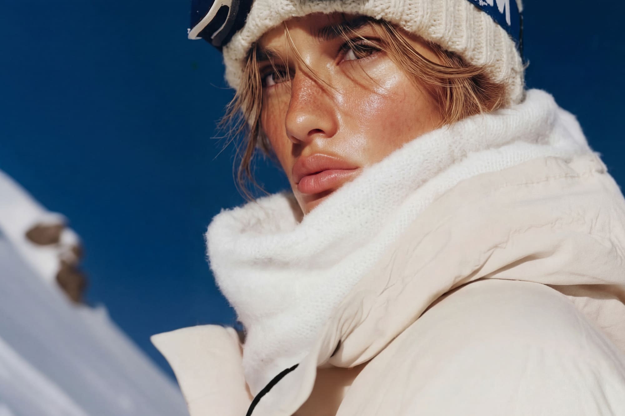 a woman wearing a hat and goggles