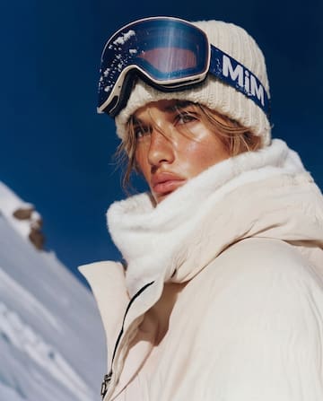 a woman wearing a hat and goggles
