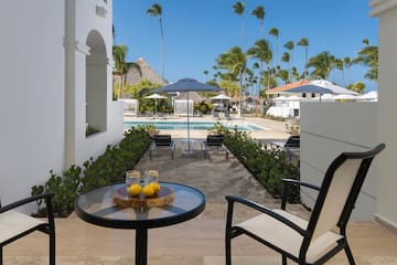 a table with two lemons on it and a pool in the background