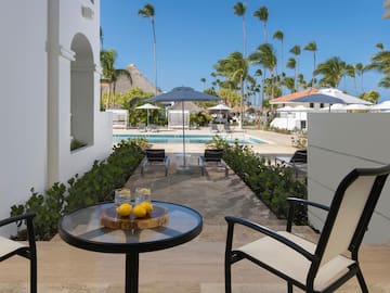 a table with two lemons on it and a pool in the background