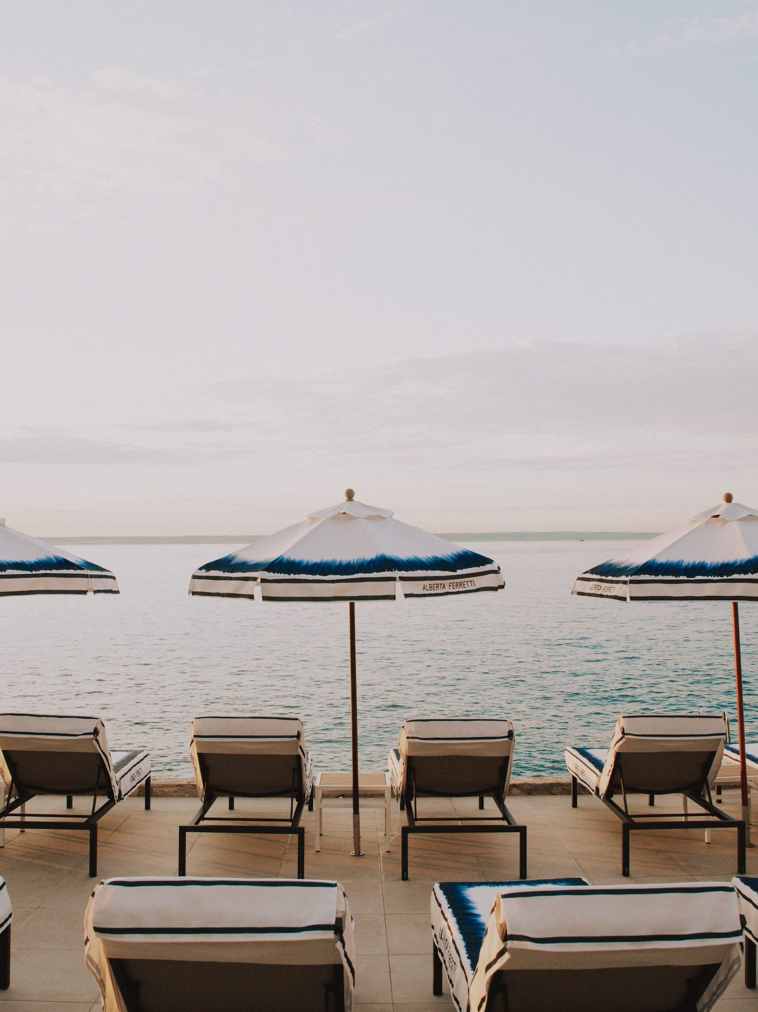 a group of chairs and umbrellas on a beach