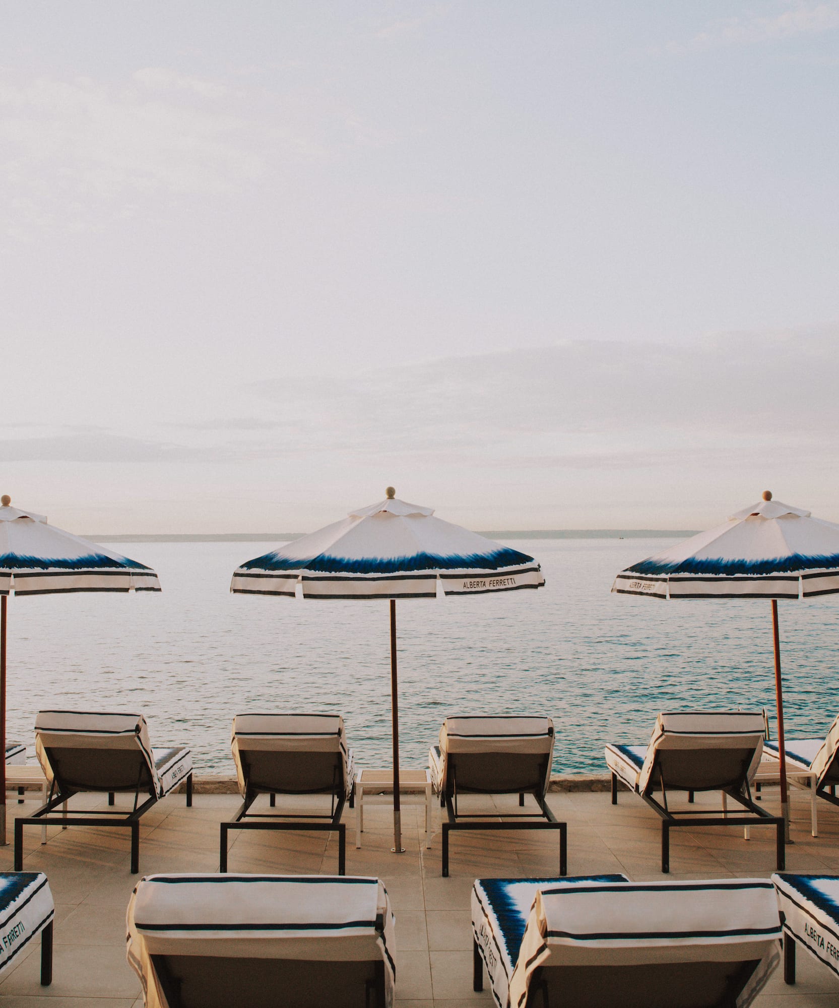 a group of chairs and umbrellas on a beach