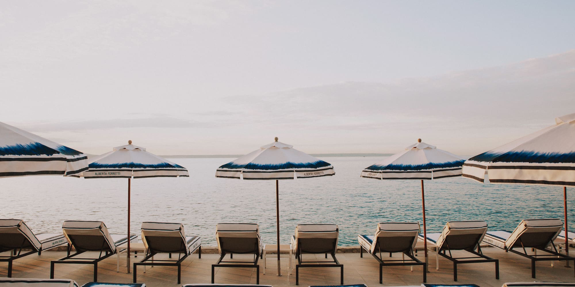 a group of chairs and umbrellas on a beach