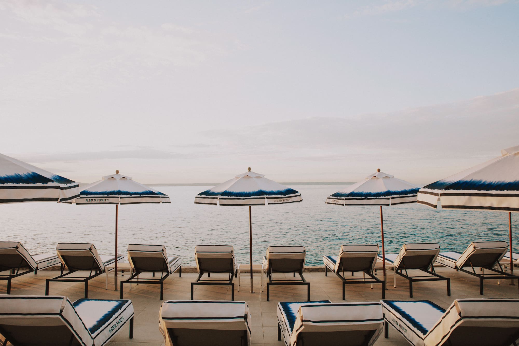 a group of chairs and umbrellas on a beach