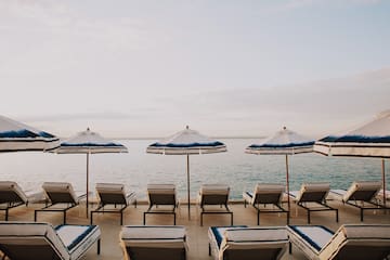 a group of chairs and umbrellas on a beach