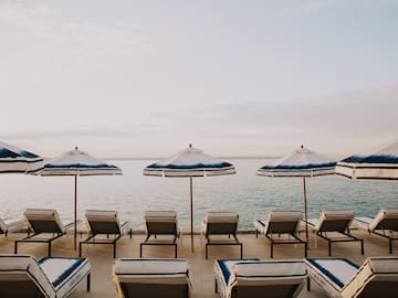 a group of chairs and umbrellas on a beach