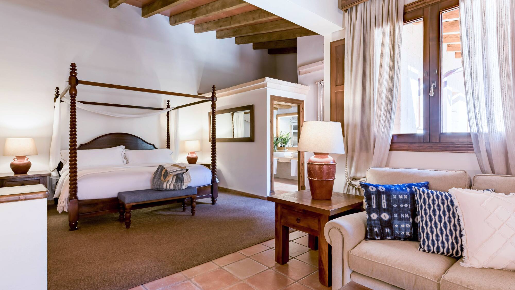 a bedroom with a bed and a couch