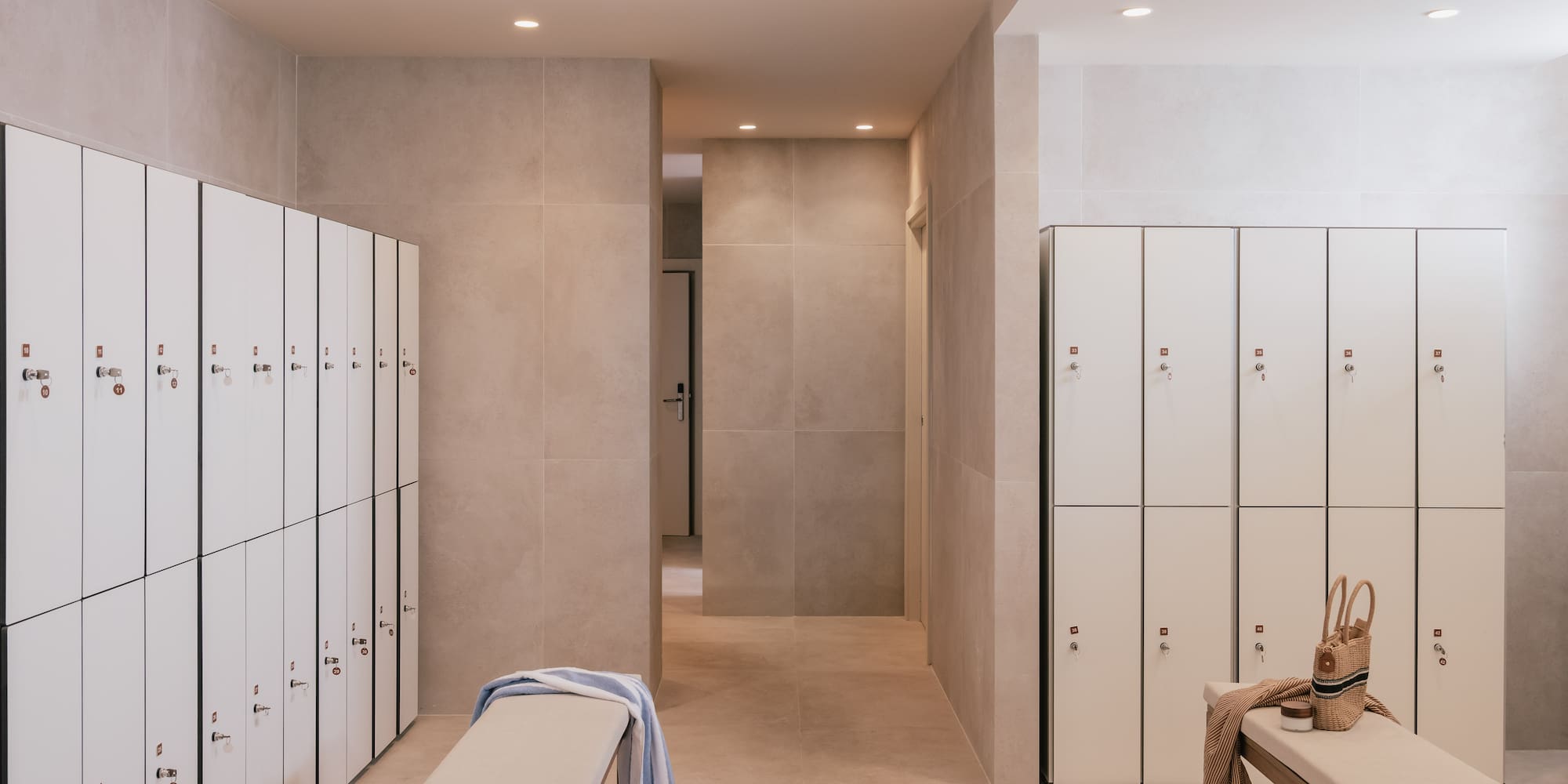 a locker room with a bench and a bench