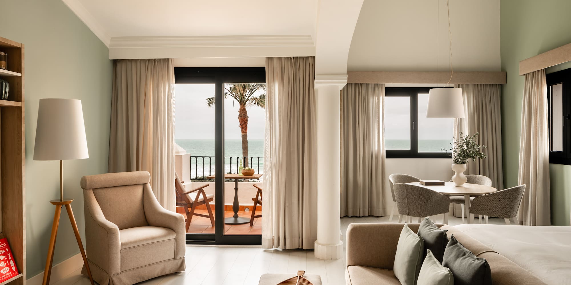 a living room with a view of the ocean