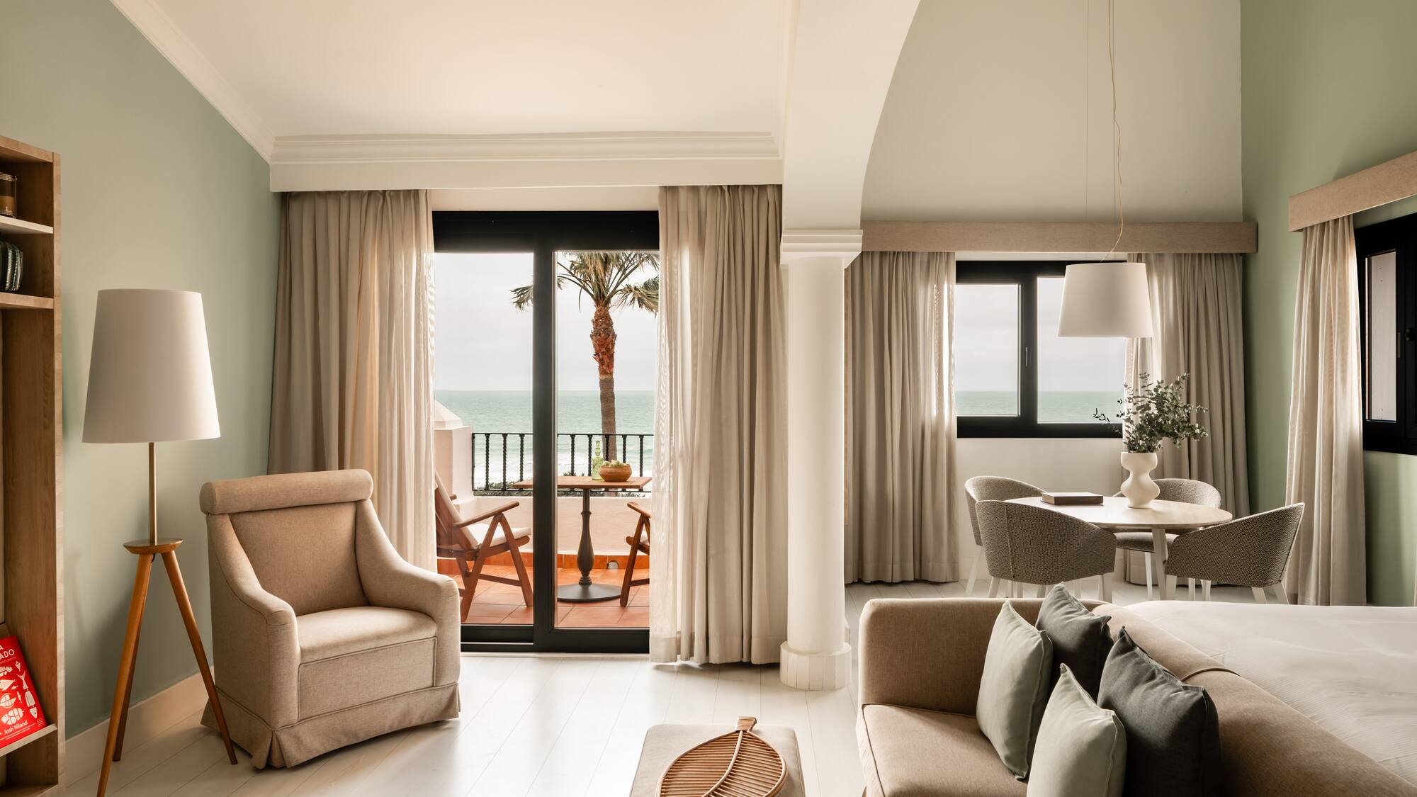 a living room with a view of the ocean