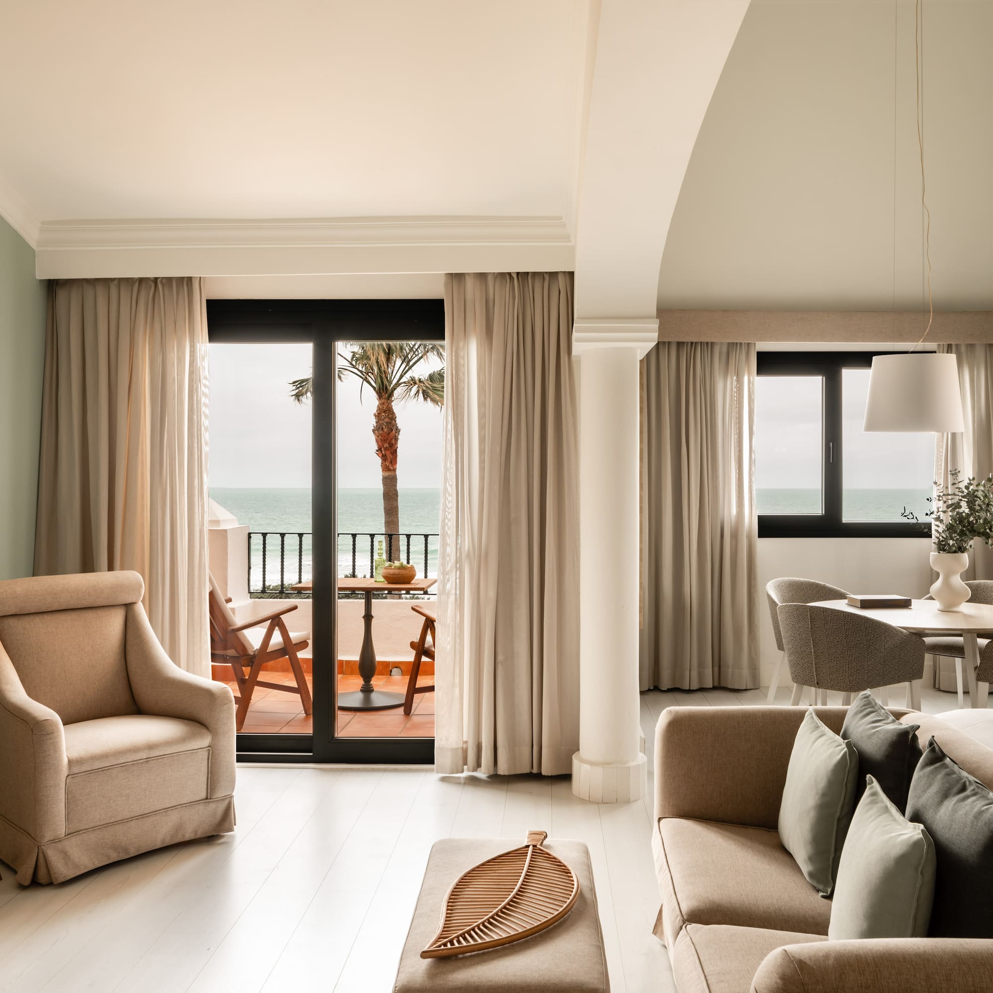 a living room with a view of the ocean