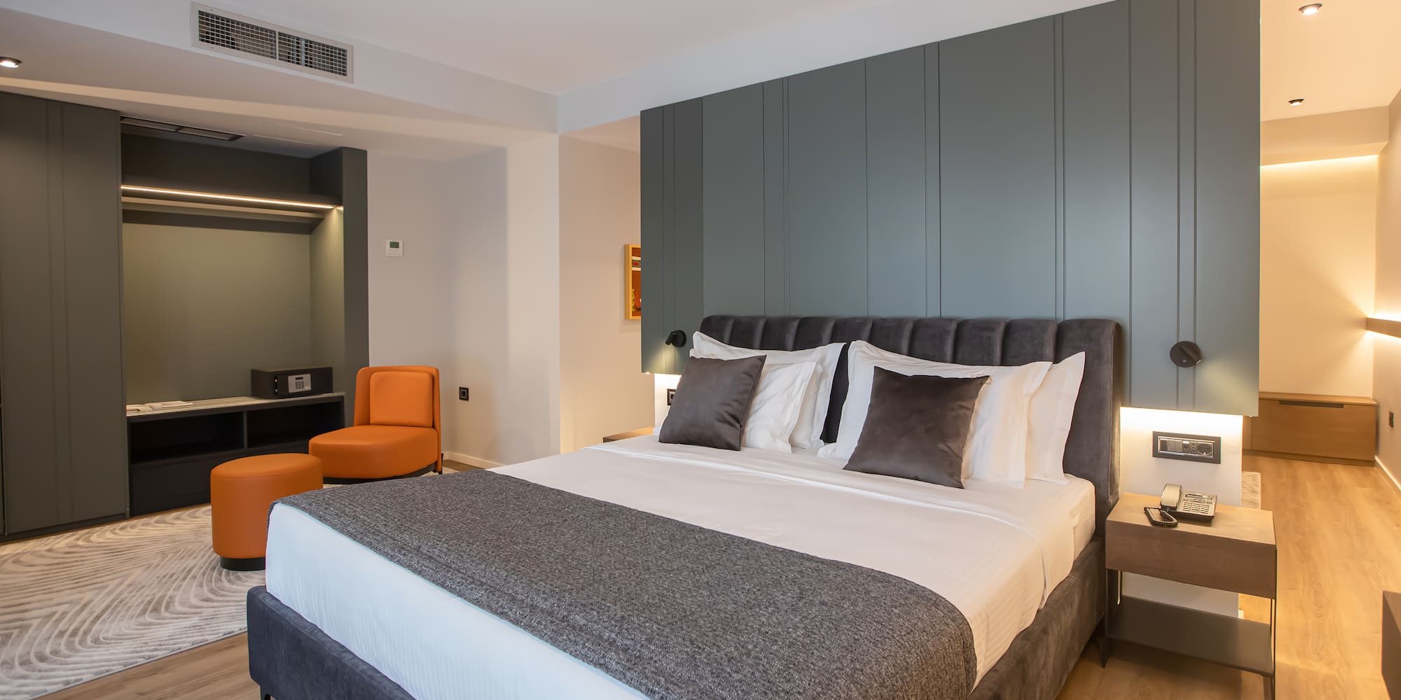 a bed with pillows and a table in a room