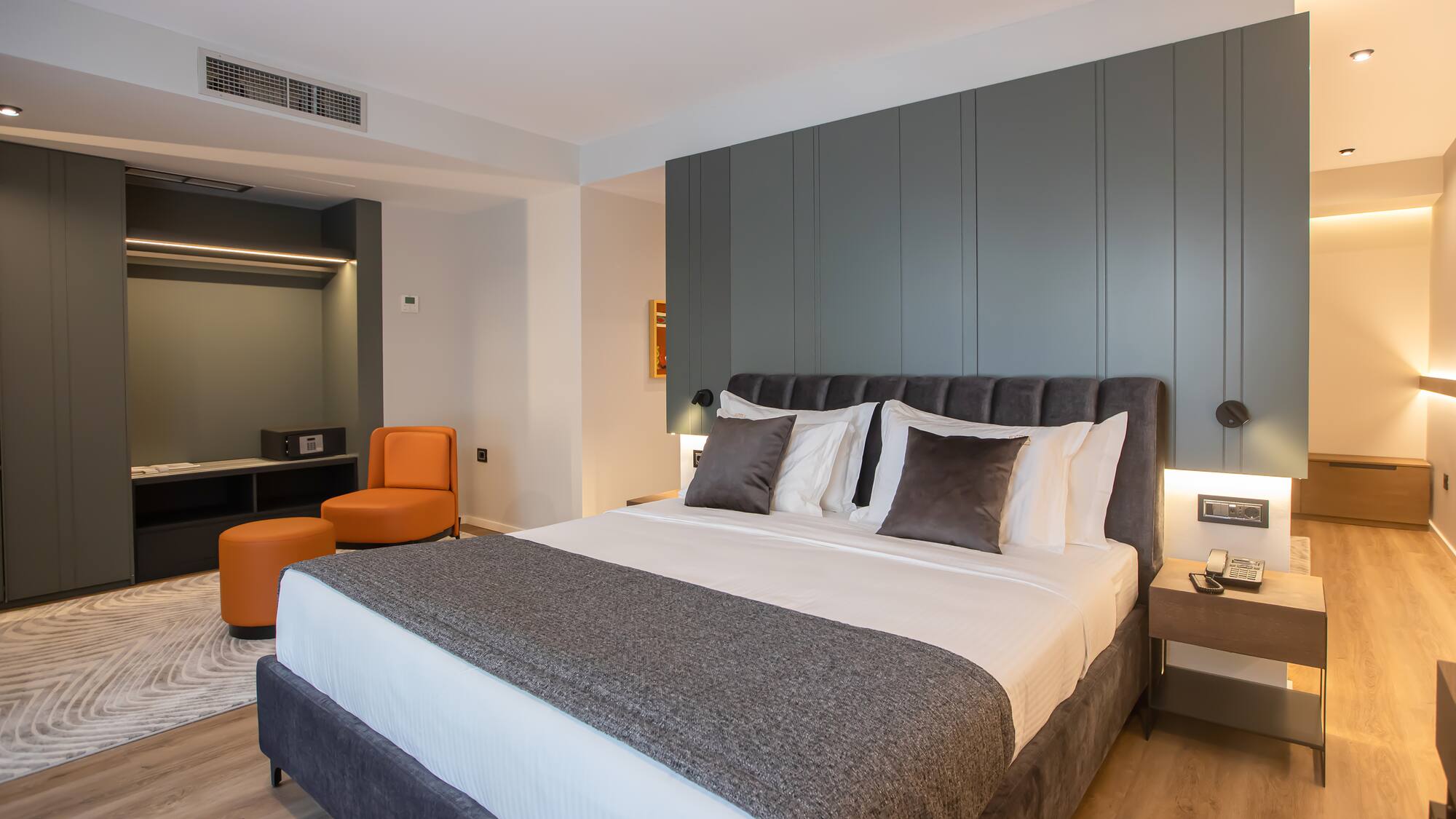 a bed with pillows and a table in a room