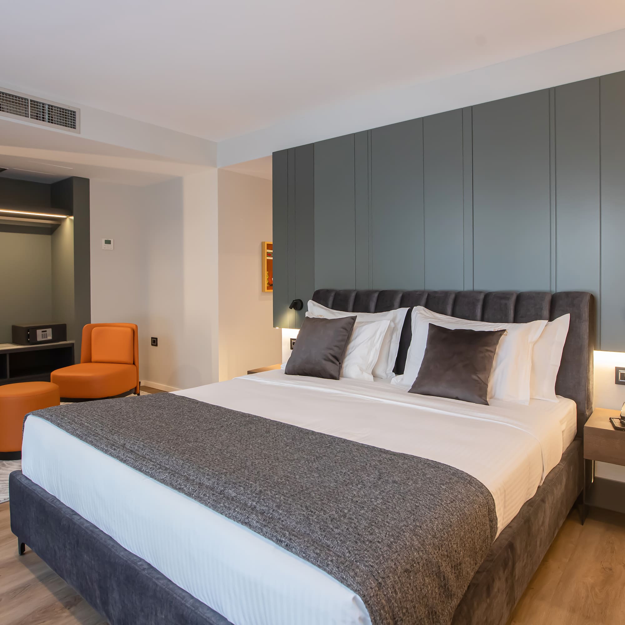 a bed with pillows and a table in a room