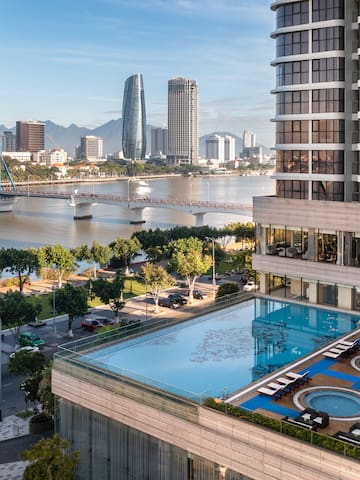 a pool in a building next to a body of water
