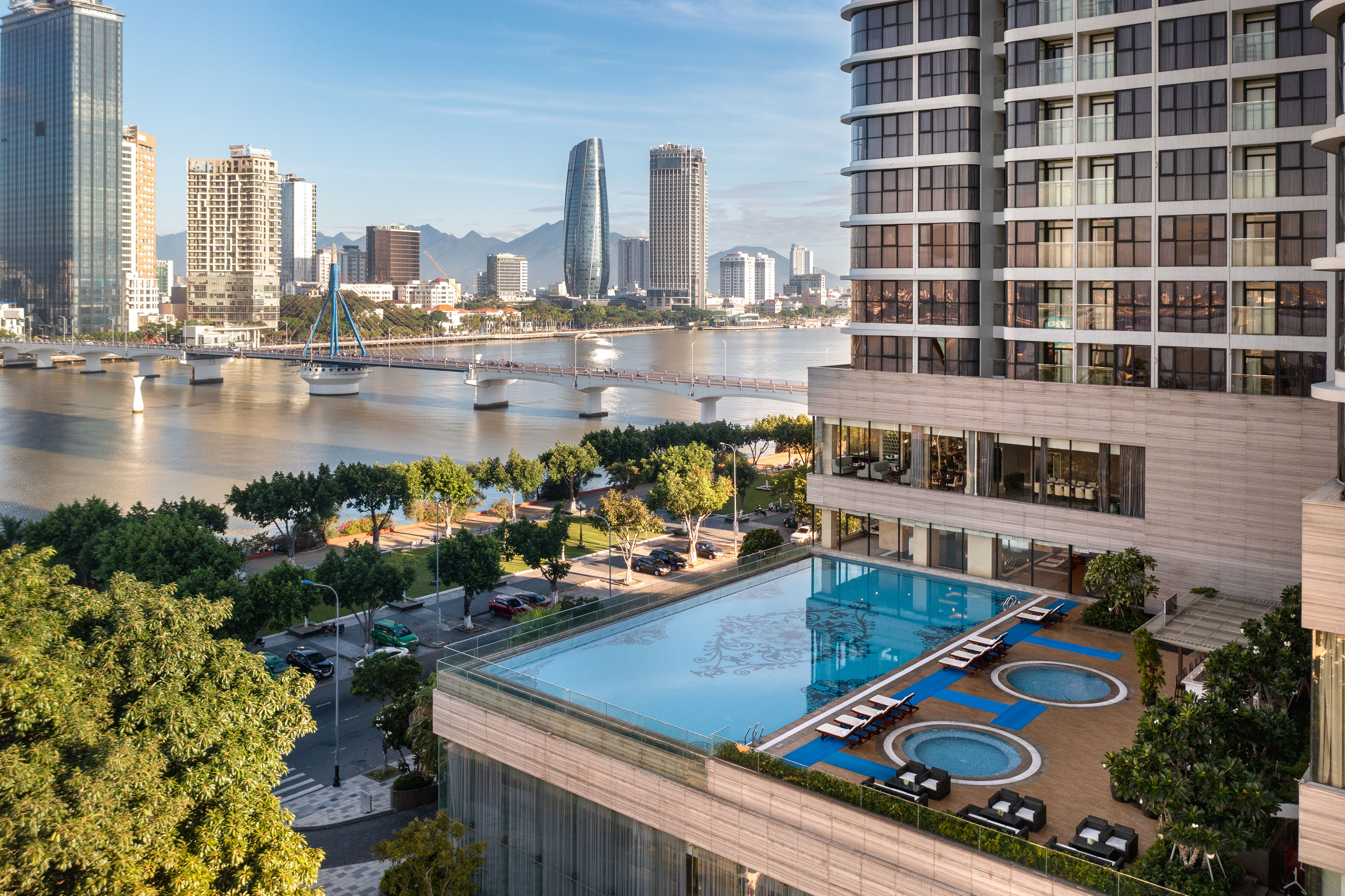 Rooftop pool and city skyline with river and bridge views, Da Nang.