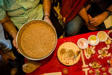 a person holding a bowl of brown rice