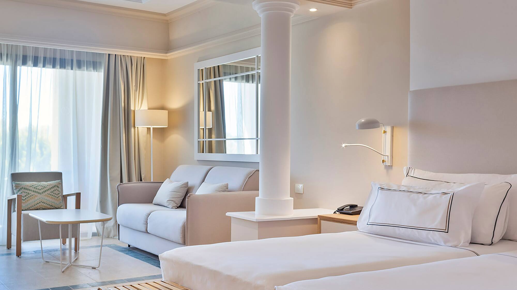 a room with a bed and couches