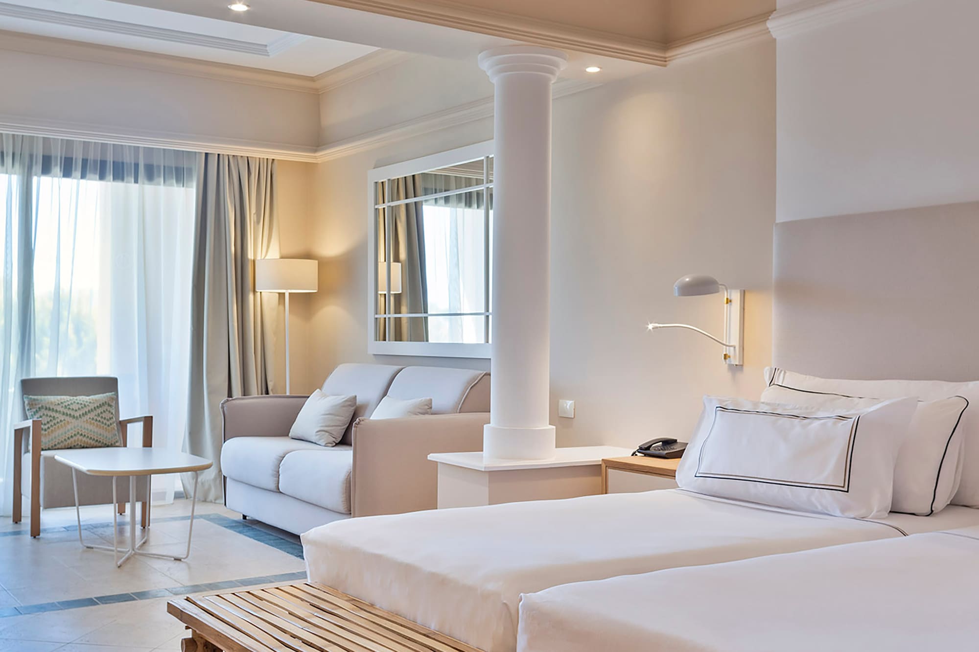 a room with a bed and couches