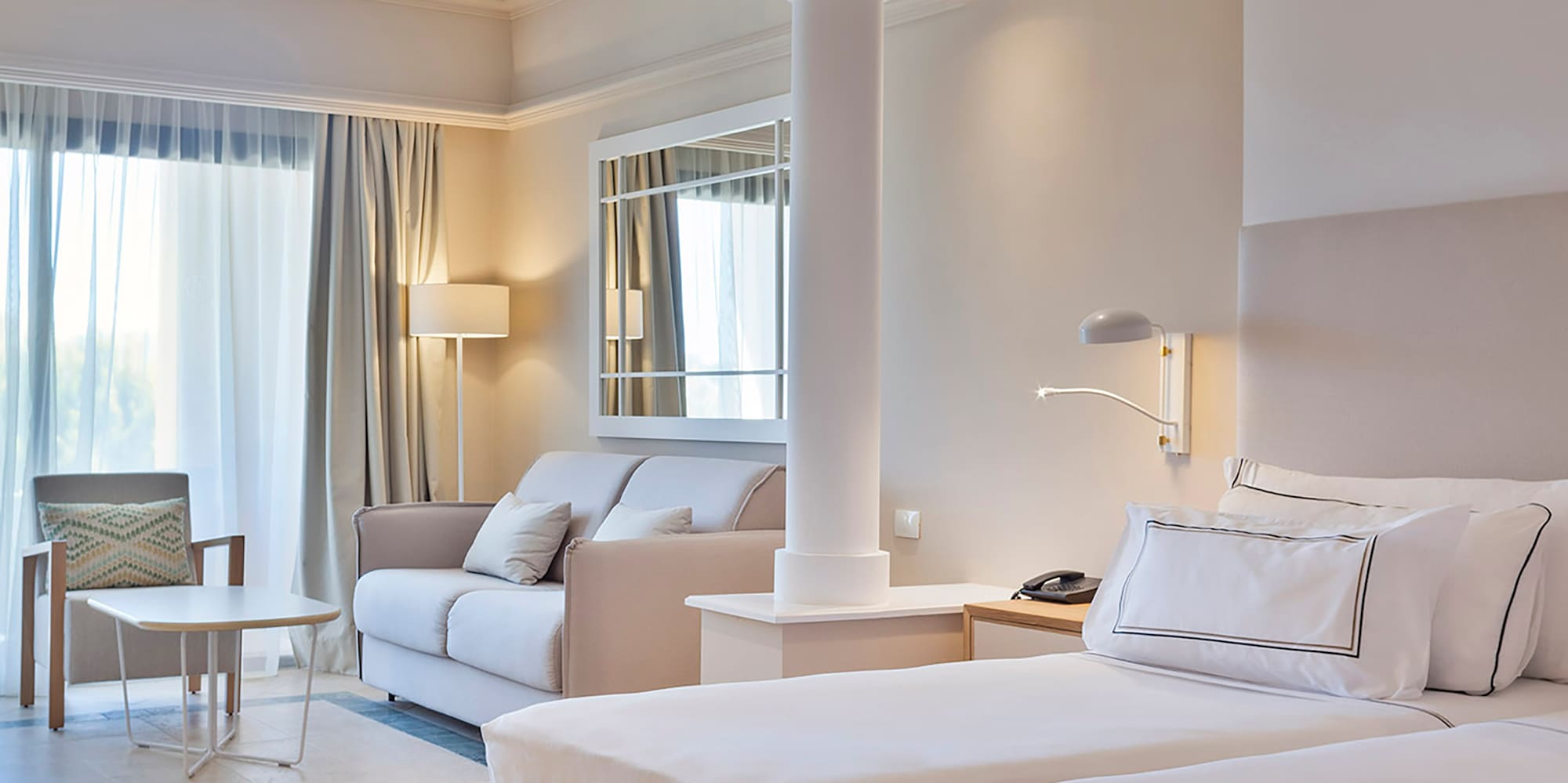 a room with a bed and couches