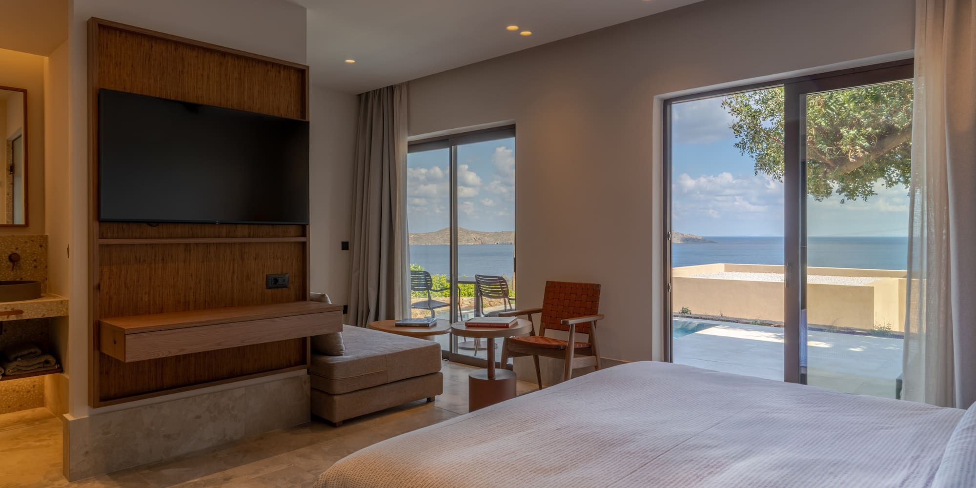 a bedroom with a large television and a large window