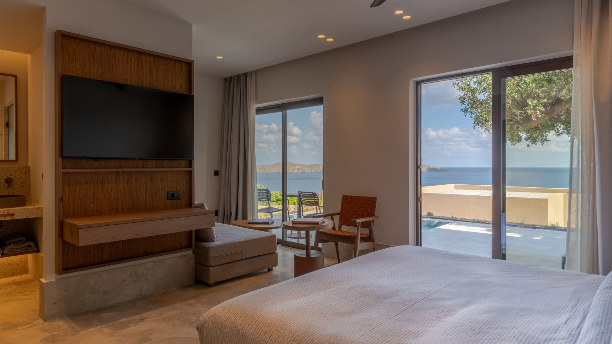 a bedroom with a large television and a large window