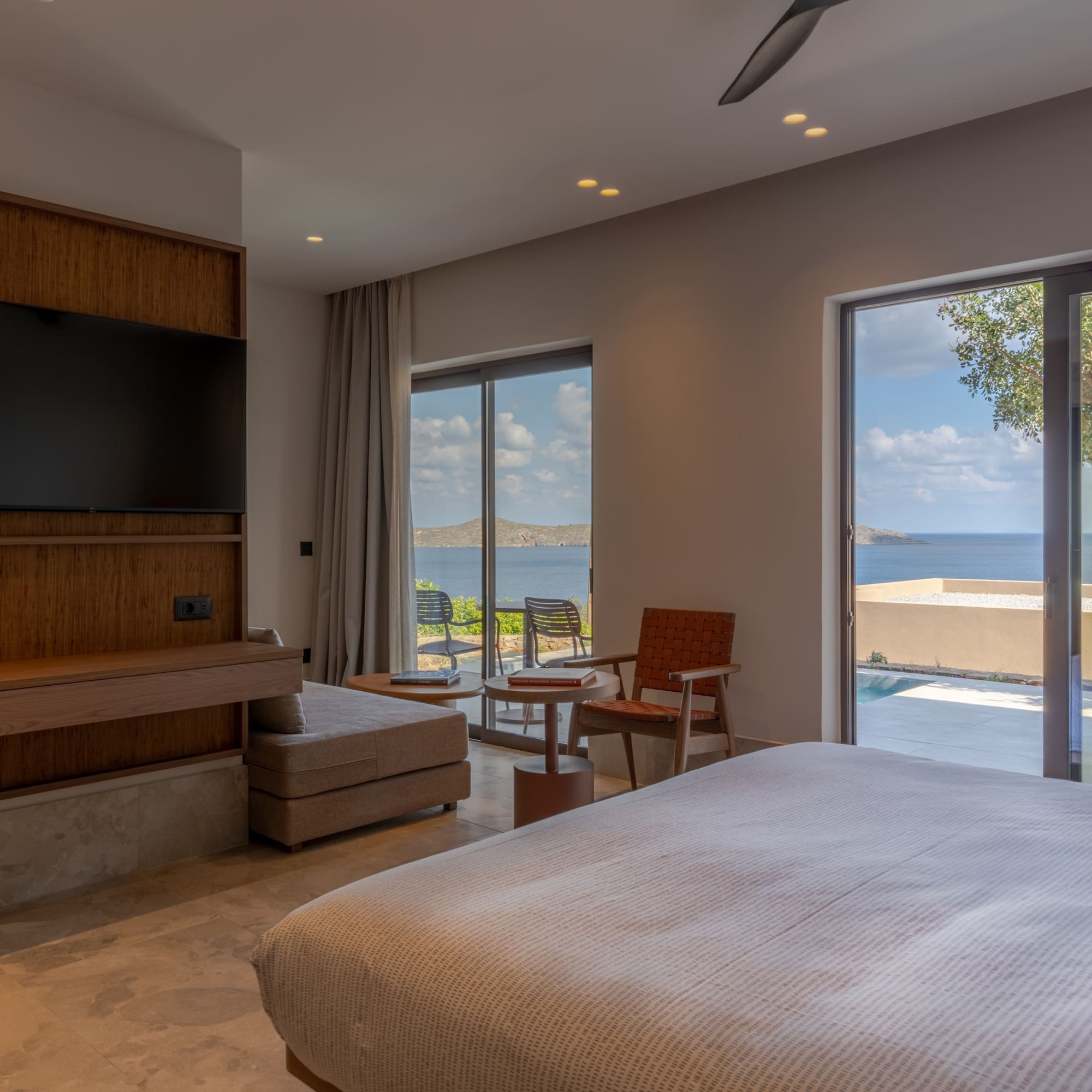 a bedroom with a large television and a large window