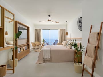 a bedroom with a bed and chairs