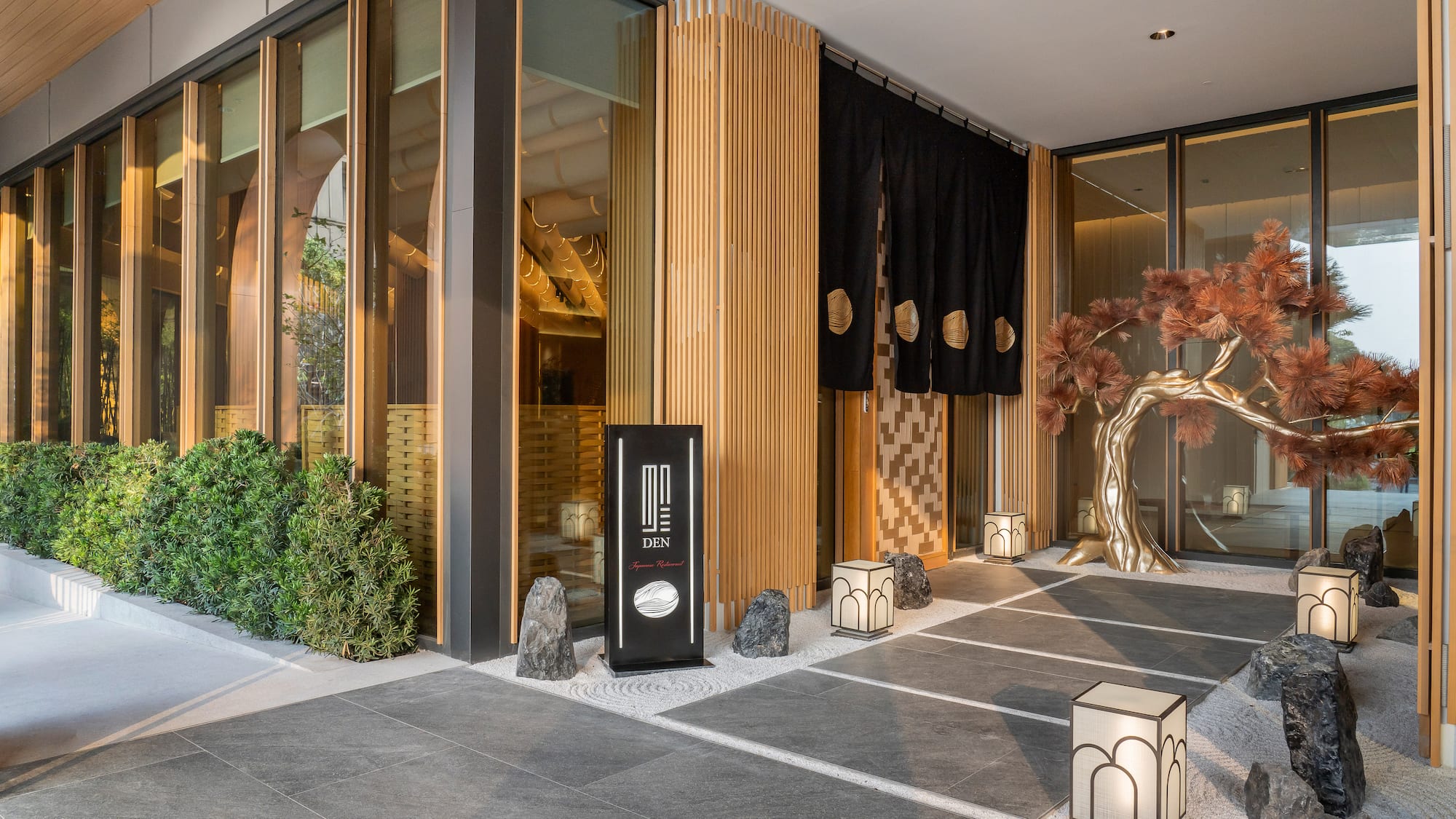 a building with a tree and lanterns
