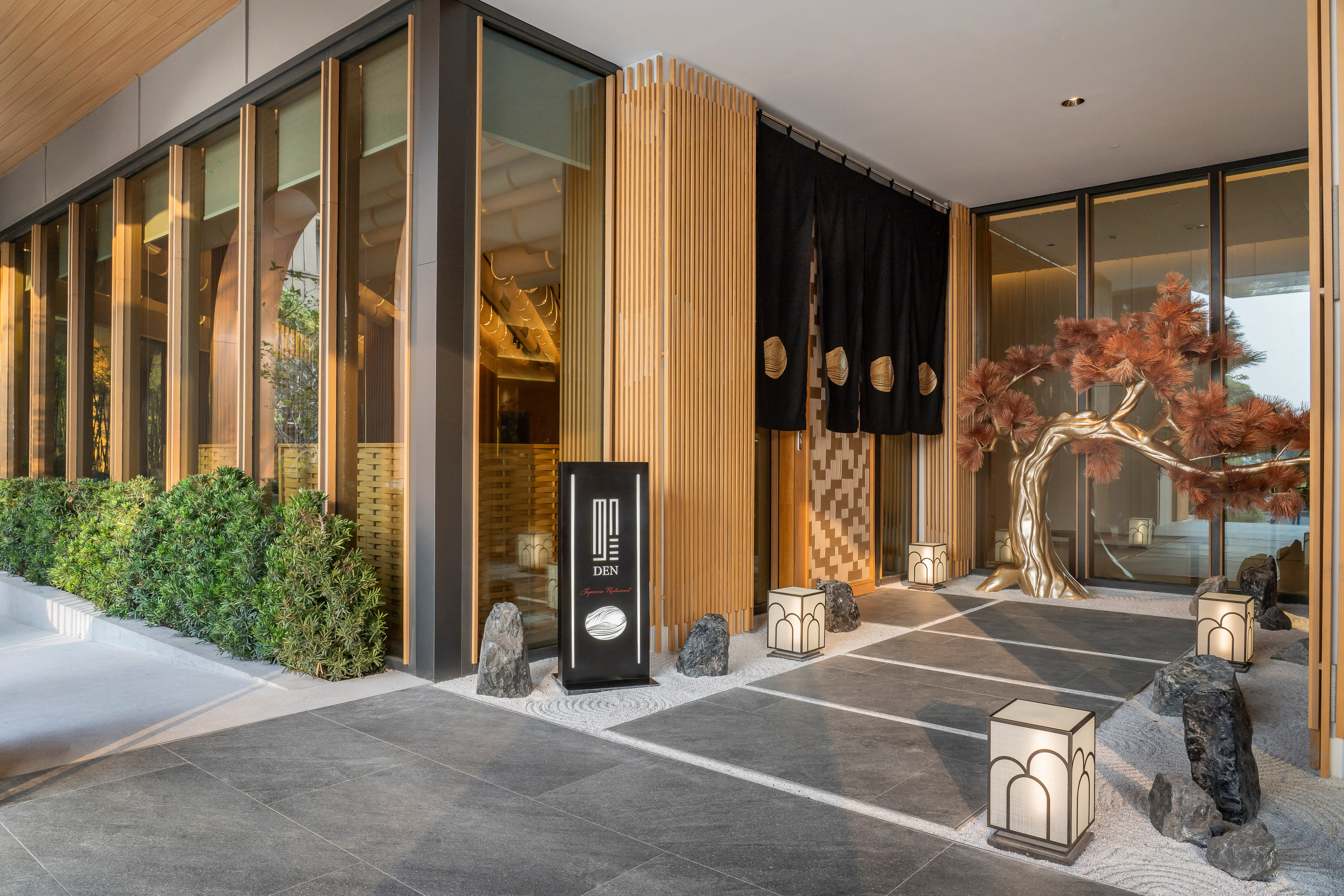 a building with a tree and lanterns