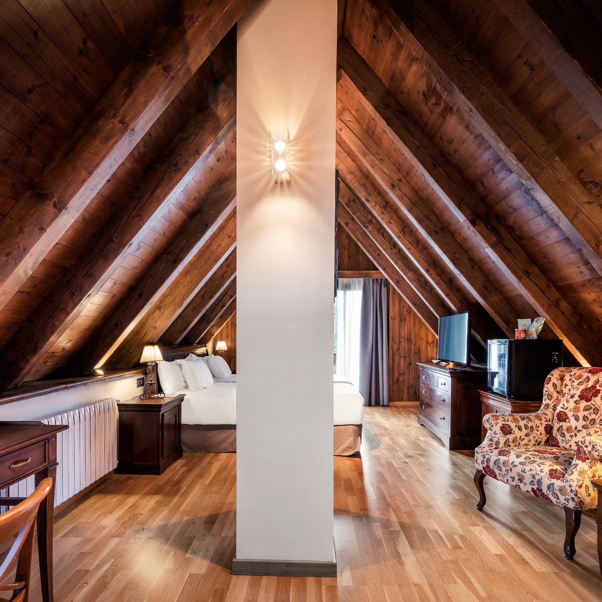 a room with a bed and a tv