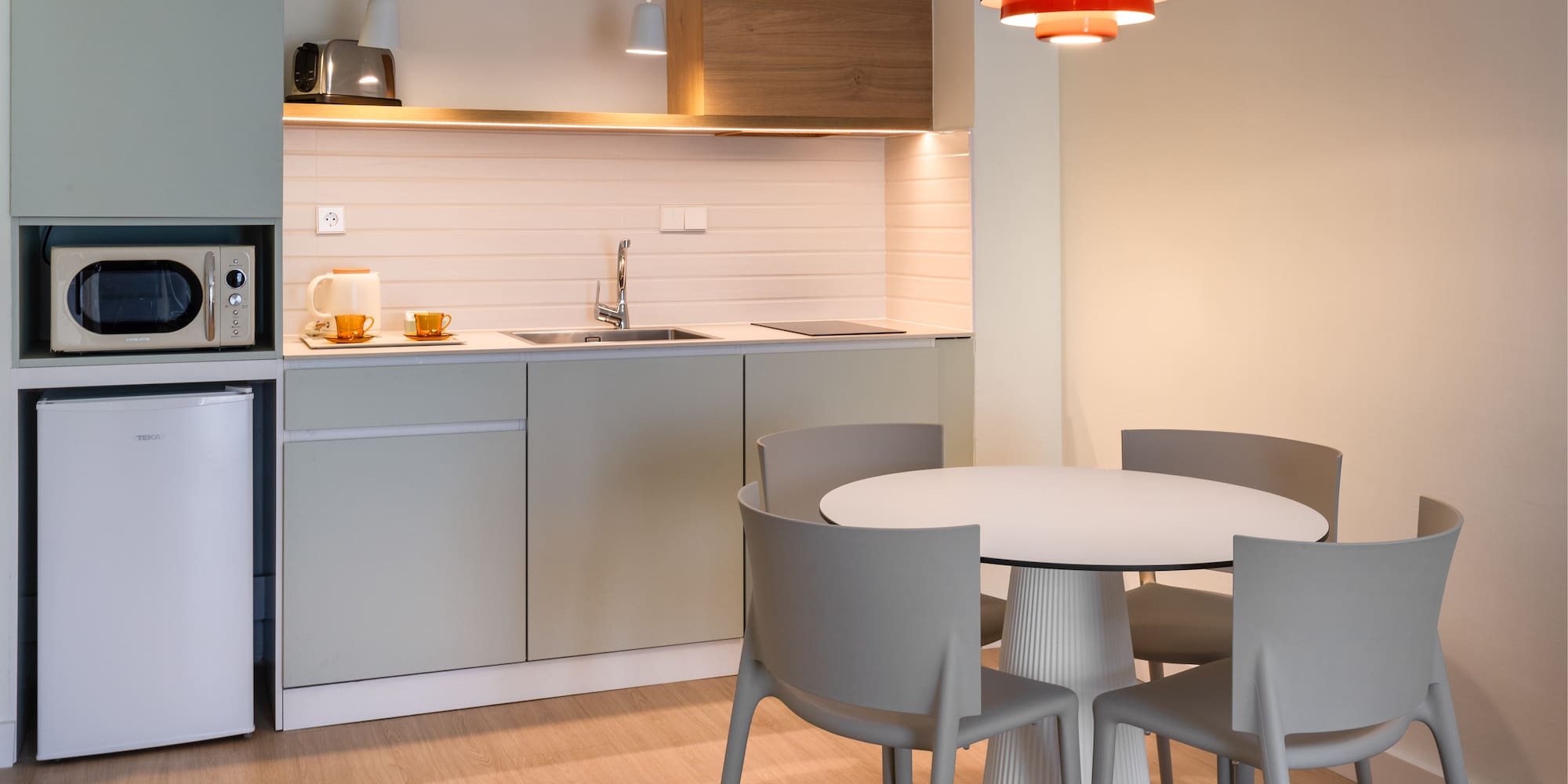 a kitchen with a round table and chairs