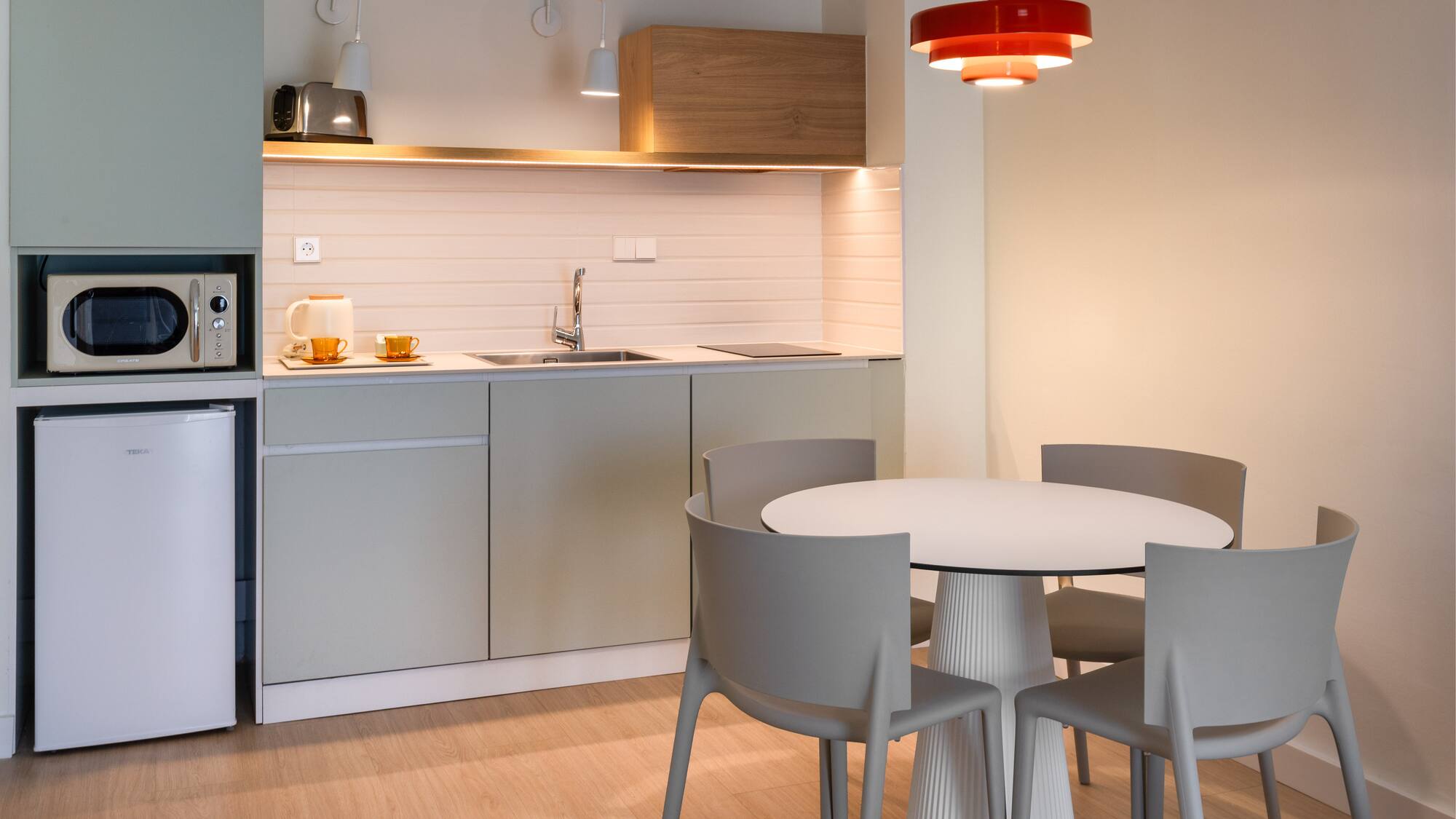 a kitchen with a round table and chairs