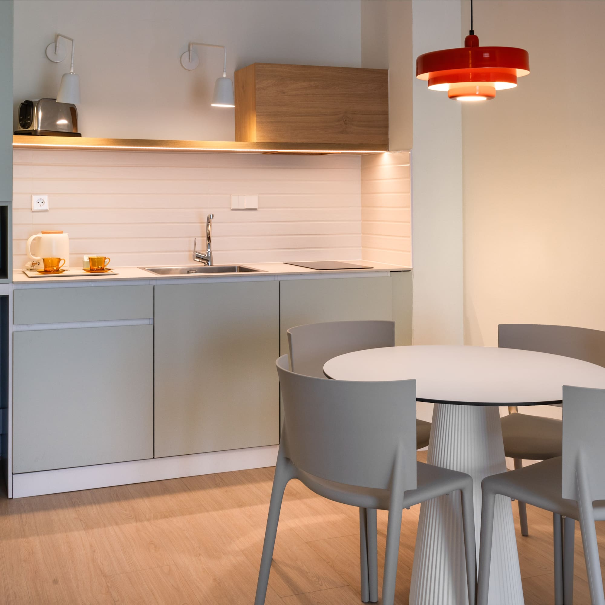 a kitchen with a round table and chairs