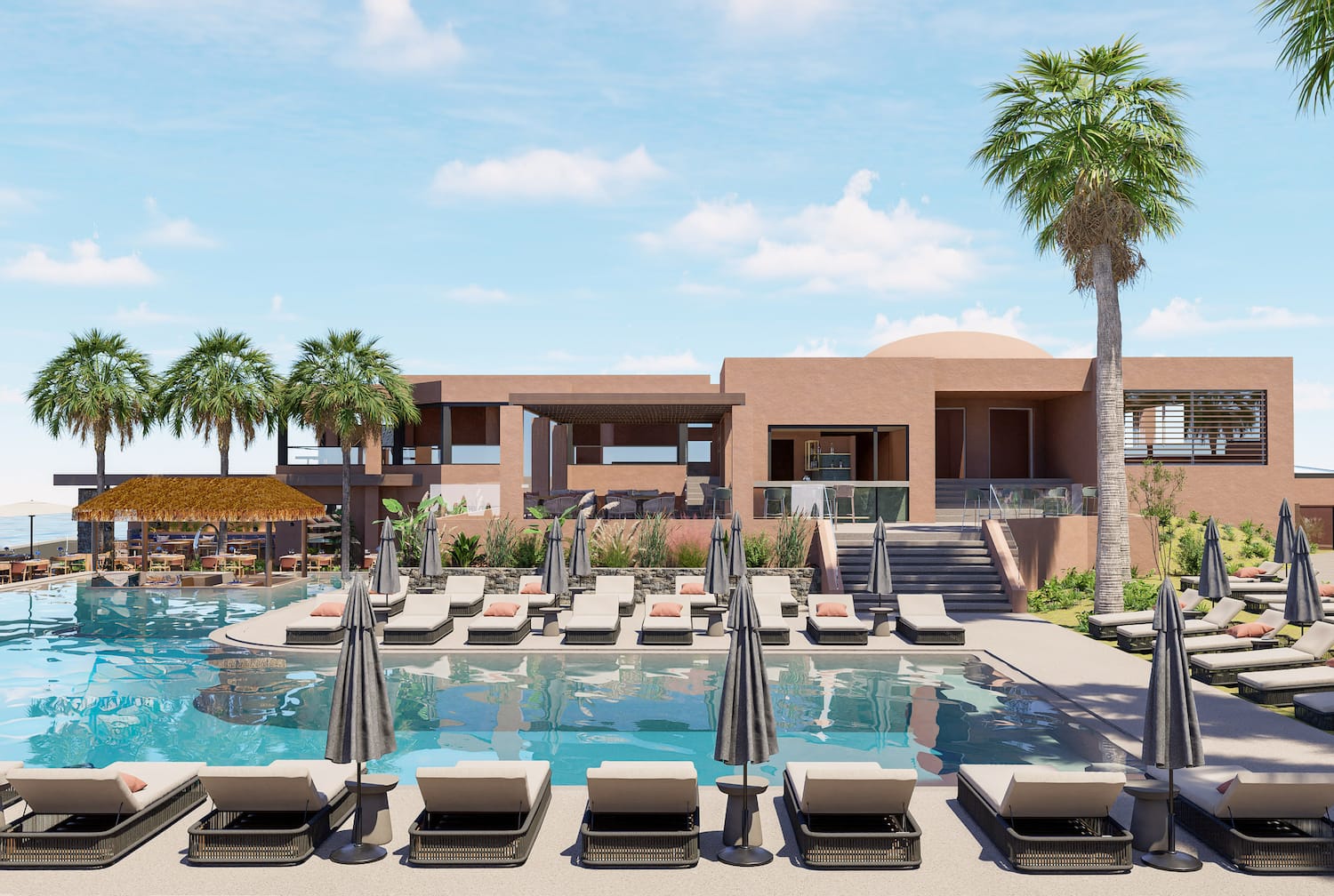 a pool with lounge chairs and umbrellas in front of a building