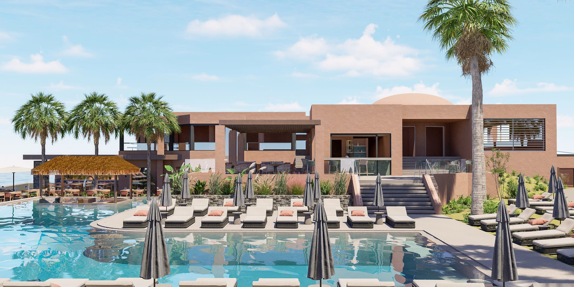 a pool with lounge chairs and umbrellas in front of a building