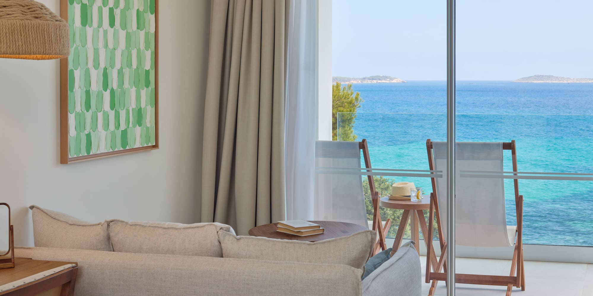 a living room with a view of the ocean