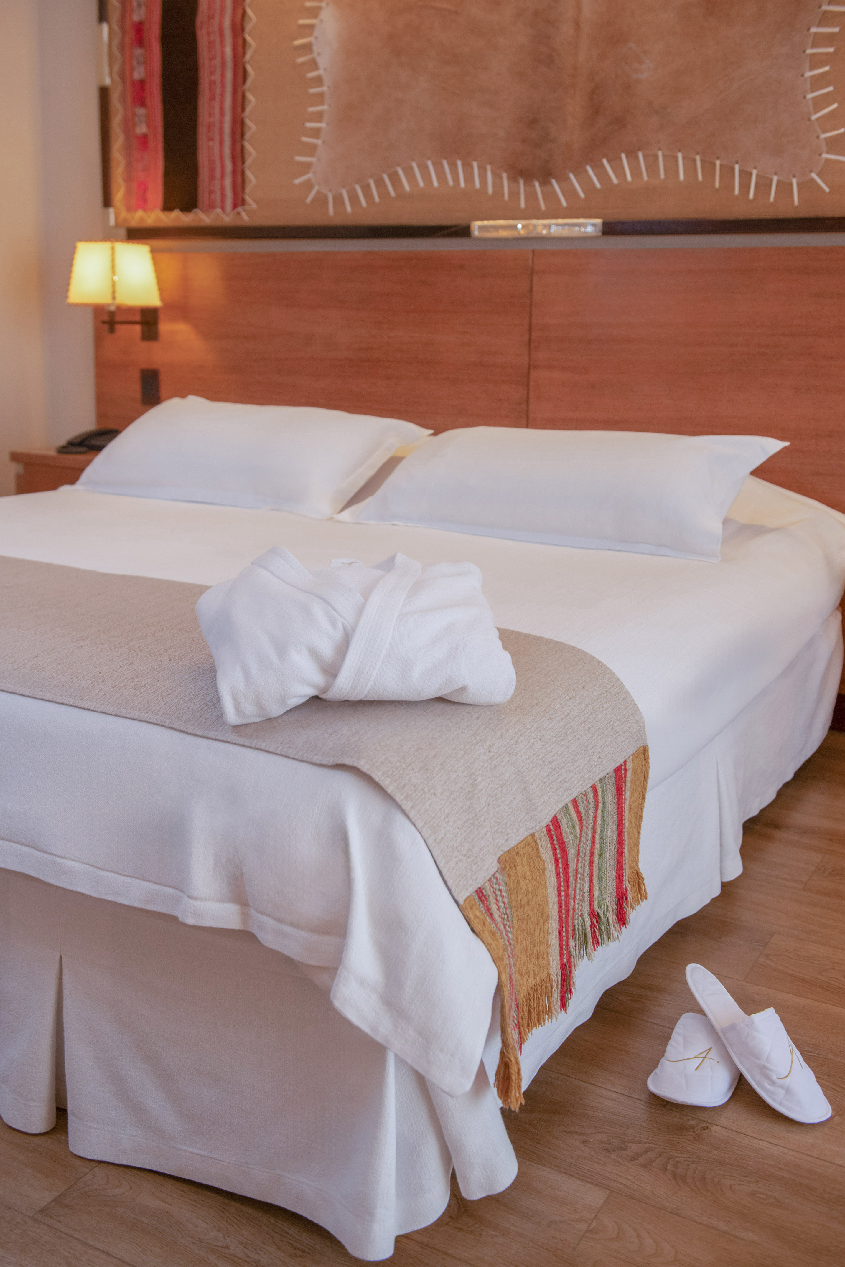 a bed with white towels and a towel on it