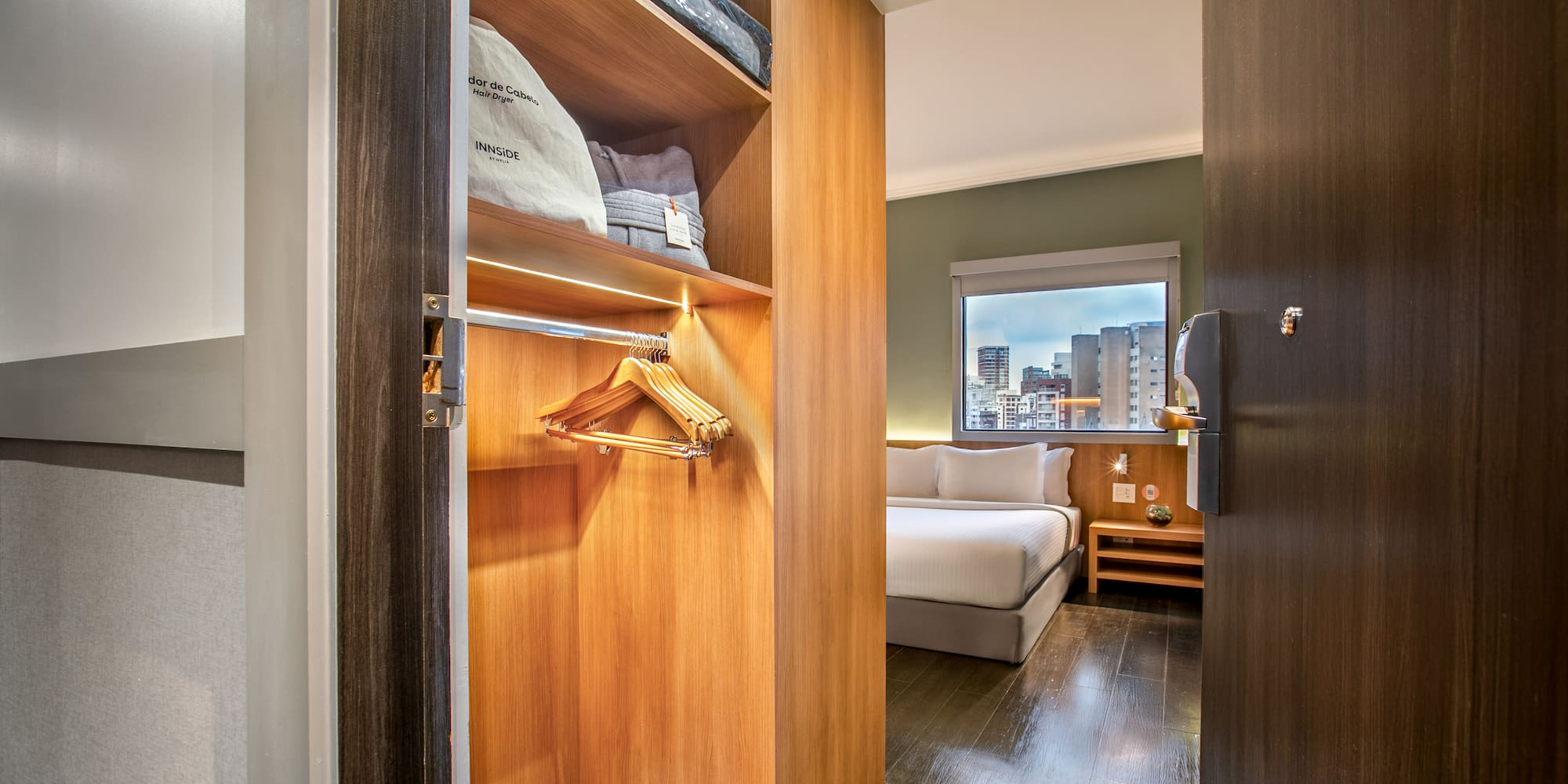a closet with a bed and shoes