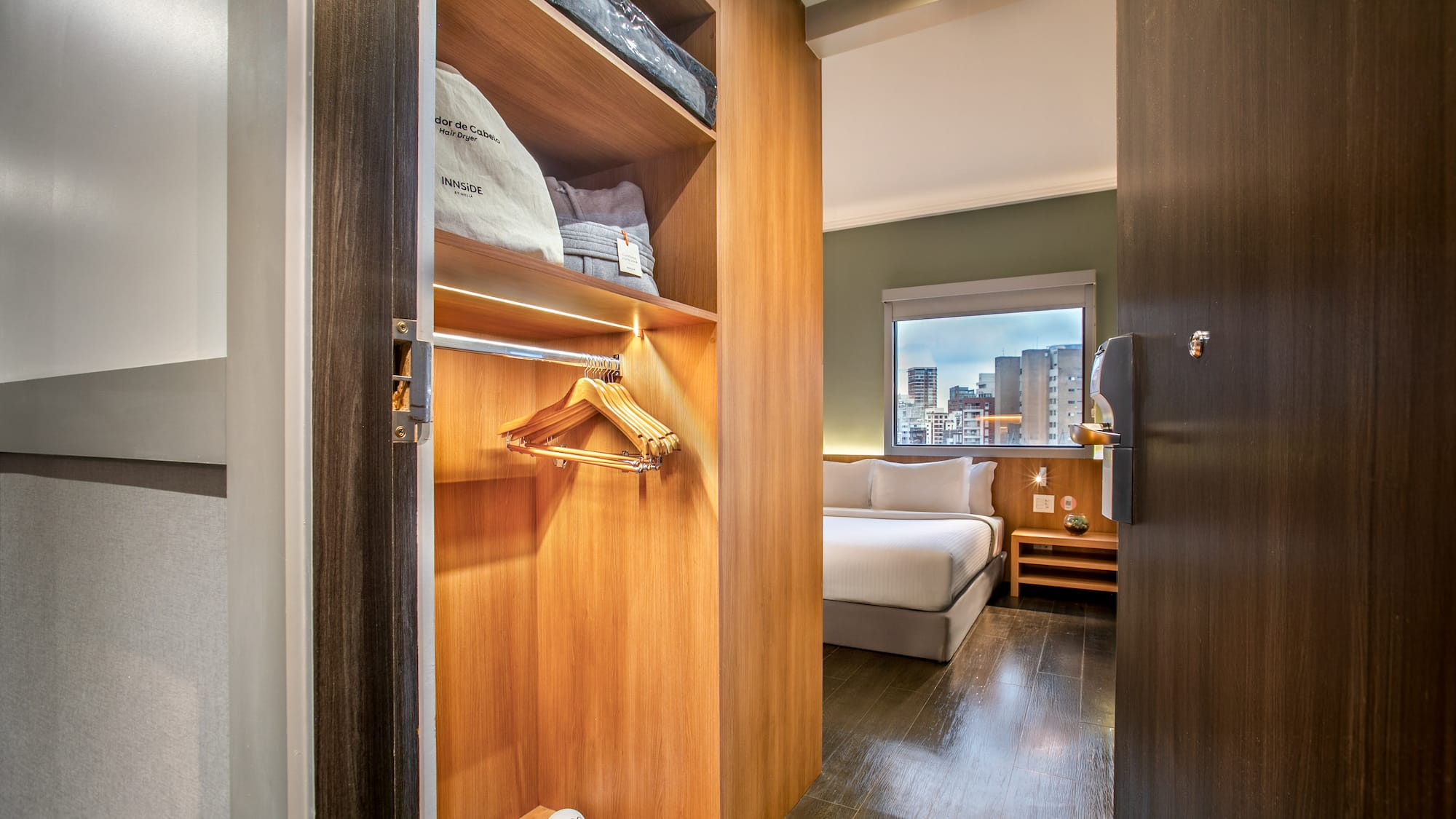 a closet with a bed and shoes