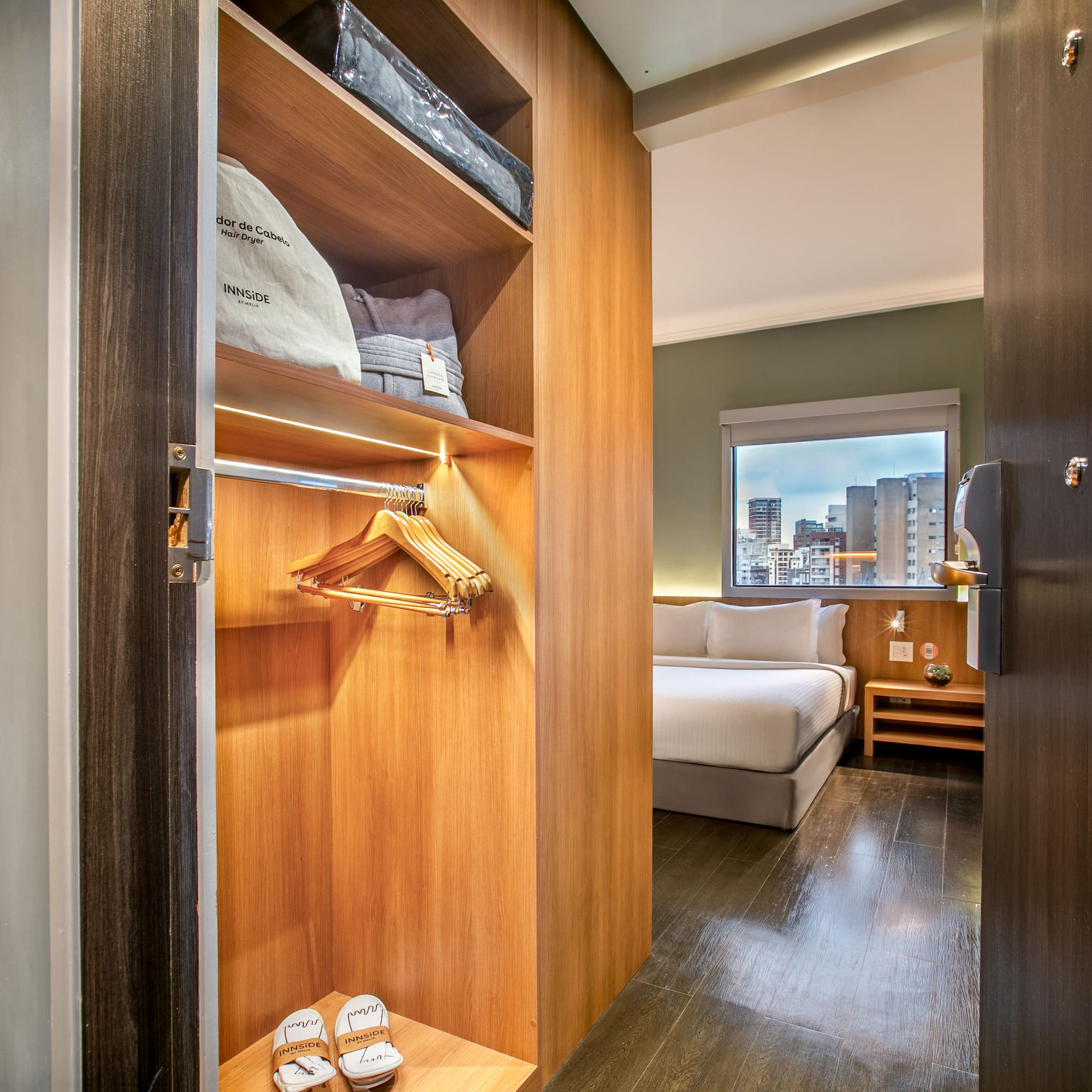 a closet with a bed and shoes