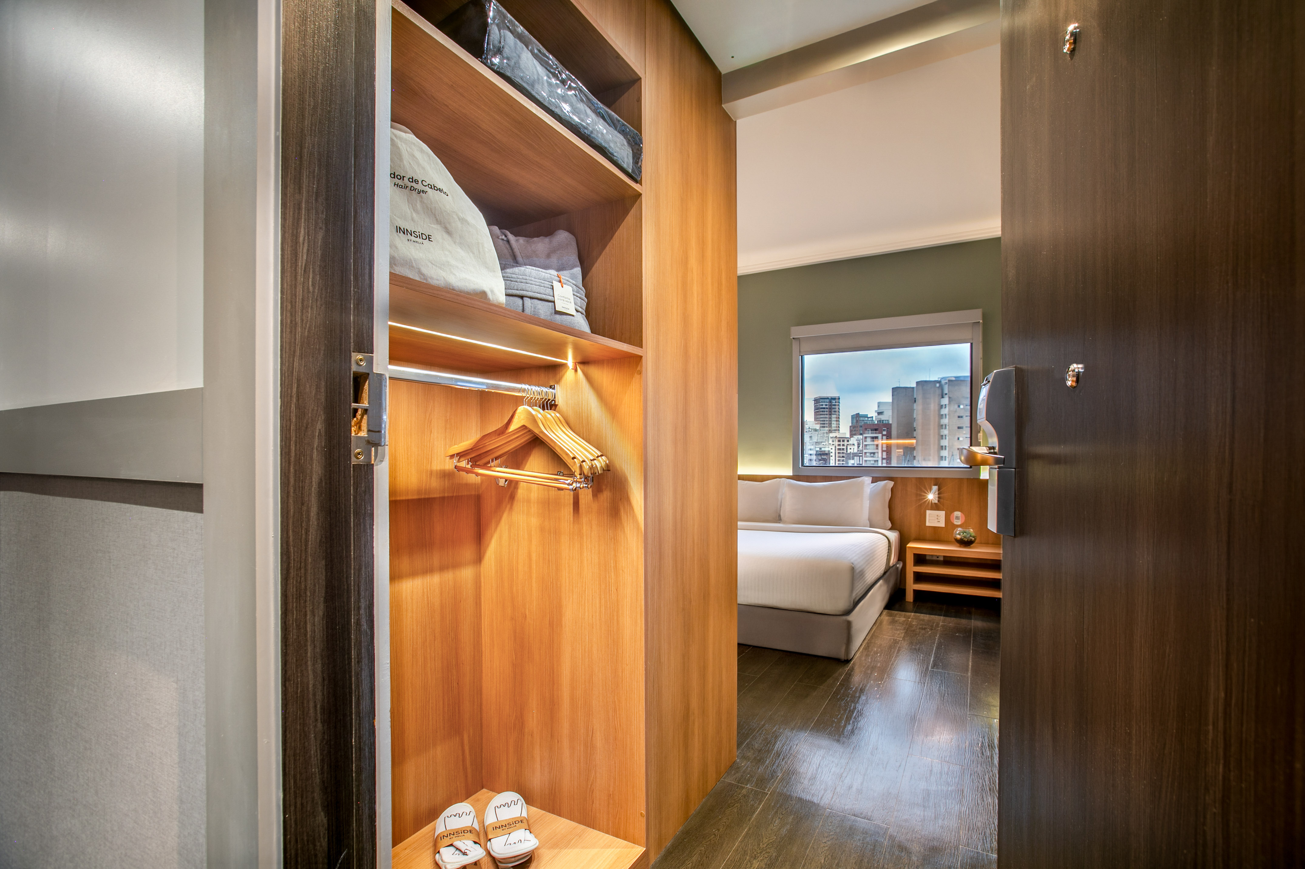 a closet with a bed and shoes